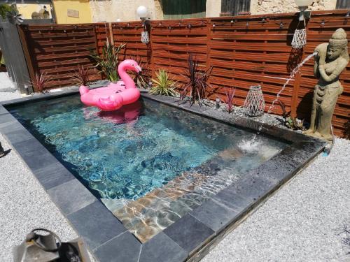 a swimming pool with a pink flamingo in it at _Linstant_zen_ in Saint-Just
