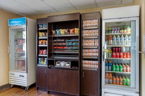 two refrigerators in a room with food and drinks at Comfort Suites DFW Airport in Irving