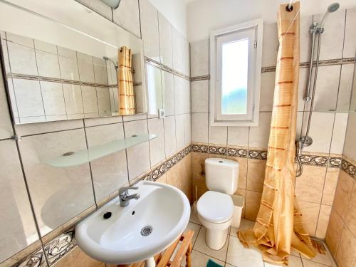 a bathroom with a sink and a toilet and a window at Apartamento C4 in Tossa de Mar