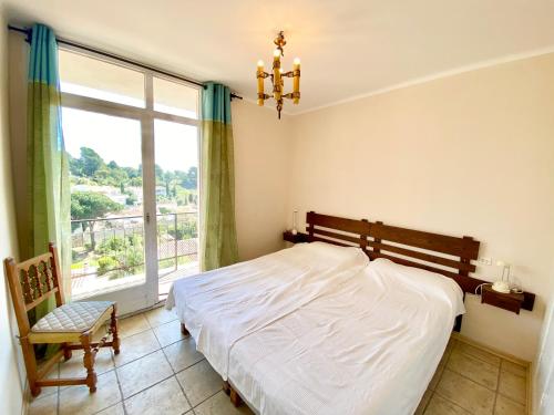 a bedroom with a bed and a large window at Apartamento C4 in Tossa de Mar