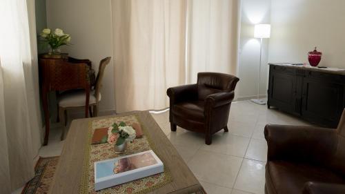 a living room with a table and a chair at Villa Morneto - Adults Only in Vignale Monferrato