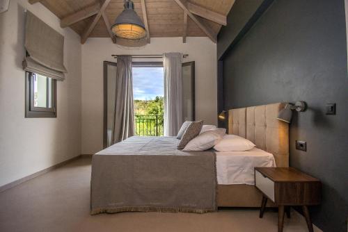 a bedroom with a large bed and a window at Luxury Villa Chrisi in Svoronata