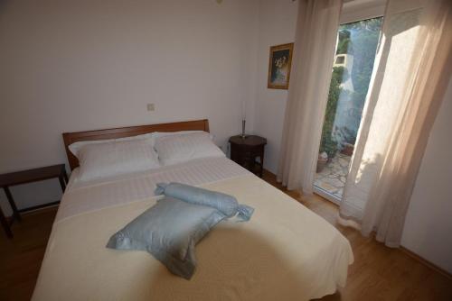 a bedroom with a bed with a pillow on it at Apartment Silva in Kornić