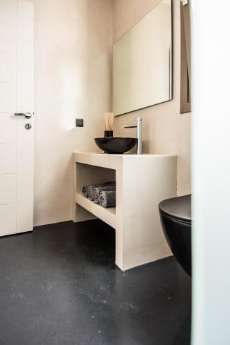 a bathroom with a sink and a black toilet at Luxury Villa Chrisi in Svoronata