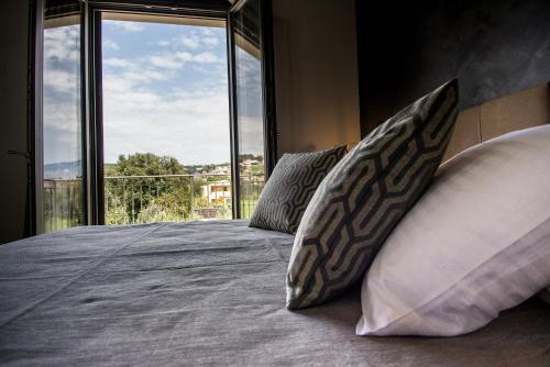 a bedroom with a bed with pillows and a window at Luxury Villa Chrisi in Svoronata
