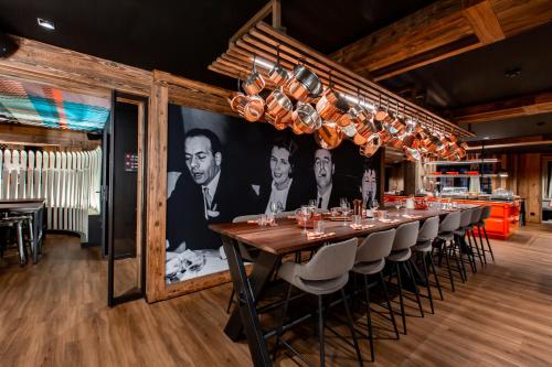 a long dining room with a long table and chairs at Hôtel Névé in Morzine