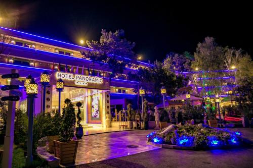 a building with blue and purple lights in front of it at Phoenicia Blue View in Olimp