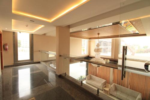 a lobby with a large window and a chandelier at RAMRATHNA RESIDENCY in Madurai
