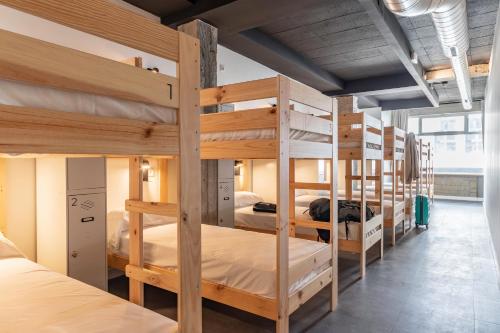 a group of bunk beds in a room at Ekoos Hostel, Bilbao Eko Hostel in Bilbao