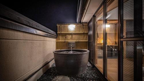 a bathroom with a tub in the middle of a room at AWA Nishi-Izu in Numazu