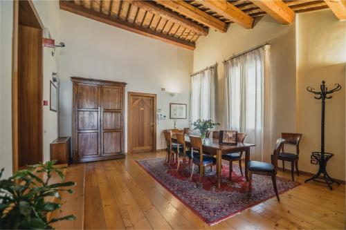a dining room with a table and chairs at Le Camere di Palazzo Bortolan in Treviso