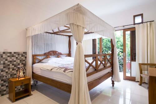Postel nebo postele na pokoji v ubytování Batik Sekar Bali Guest House