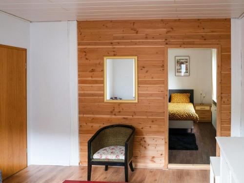 Habitación con pared de madera, espejo y cama. en Apartment in Brilon with a small garden, en Brilon