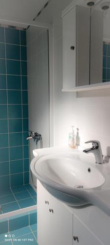 a bathroom with a white sink and a shower at Villa Andoni in Othonoi