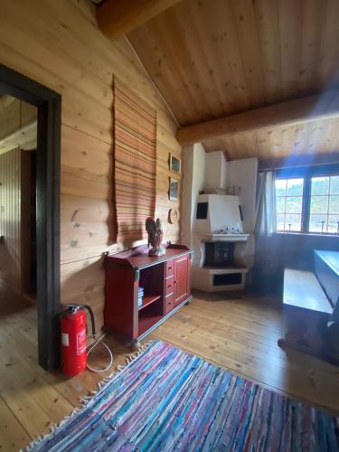 a living room with a stove in a log cabin at Morgedal Camping in Morgedal
