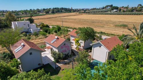an overhead view of a row of houses in a field at YalaRent Valley view complex In Merhavia with Private Pool in Merhavyāh