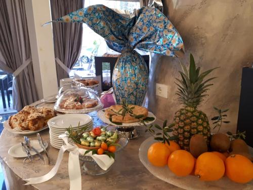a table topped with plates of food and fruit at The Moon Boutique Hotel & Spa in Florence