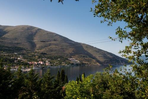 a large body of water with a mountain in the background at MAKRIS HOUSE in Ayia Evfimia