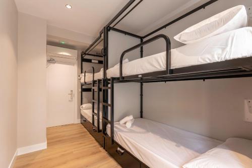 a group of bunk beds in a dorm room at Uri Hostel Bilbao Rooms BBI00060 Self check in in Bilbao
