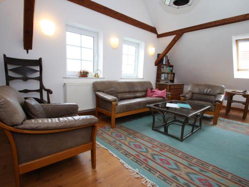 a living room with couches and a coffee table at XXL Ferienhaus mit Sauna in Upost in Upost