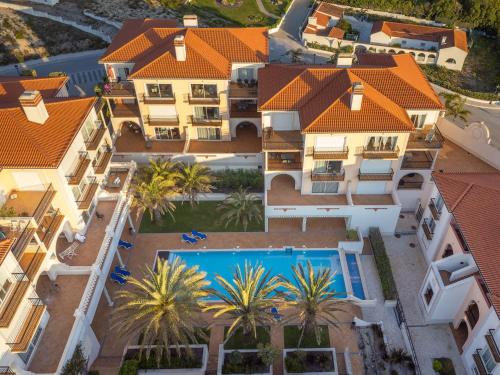 an aerial view of a mansion with a swimming pool at Stunning Sea View Apartment Praia D'El Rey in Casal da Lagoa Seca