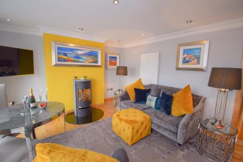 a living room with a couch and a table at Outlander Glencoe at Creag an-t Sionnaich Glencoe Ballachulish Highlands Near Fort William in Glencoe