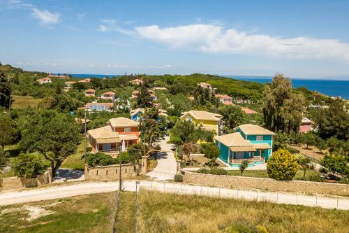 an aerial view of a village with houses and the ocean at Porto Gerakas Villas in Vasilikos