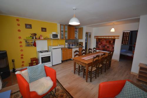 a kitchen and dining room with a table and chairs at Essentiel Barret in Barret-sur-Meouge
