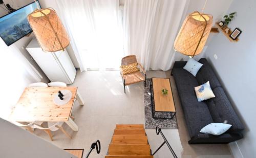 an overhead view of a living room with a couch and a table at YalaRent Valley view Boutique cottages with Pool in Merhavyāh
