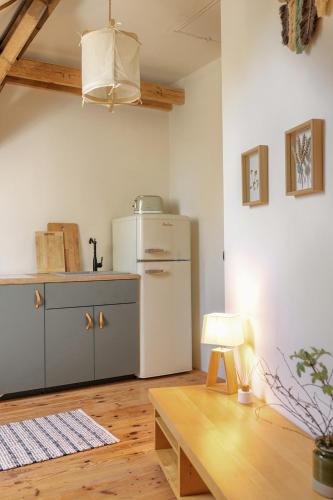a kitchen with a white refrigerator and a table at Prywatna Wieś in Mörken
