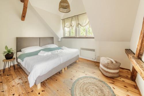 a bedroom with a large bed and a window at Prywatna Wieś in Mörken