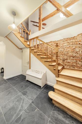 a staircase in a living room with a brick wall at Prywatna Wieś in Mörken