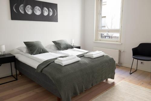 a bedroom with a large bed with towels on it at 2ndhomes Cozy Courtyard home with Sauna in Kruununhaka in Helsinki