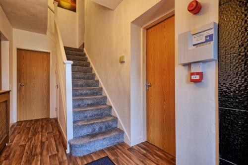 a stairway in a home with a blue carpet at Upton Village Guest House in Birkenhead