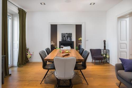 a dining room with a wooden table and chairs at Charlie Chaplin in Split