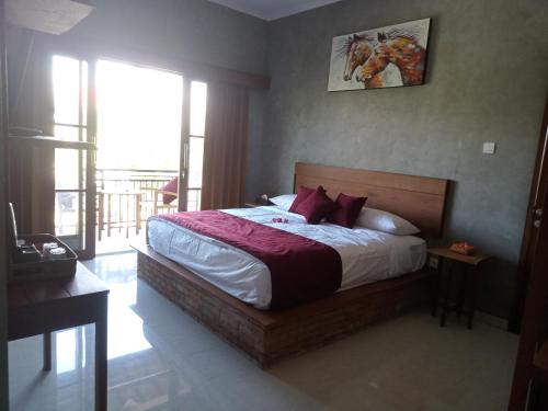 a bedroom with a large bed with red pillows at Araya villa saba in Saba