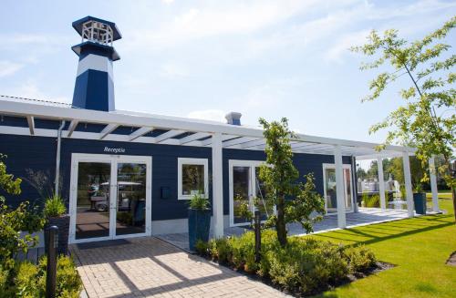 a blue building with a lighthouse on top of it at EuroParcs Bad Hulckesteijn in Nijkerk