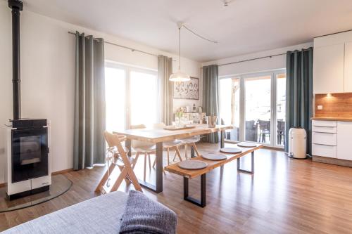 a kitchen and dining room with a table and chairs at Lipno - Lakeside Village - Větrník in Frymburk