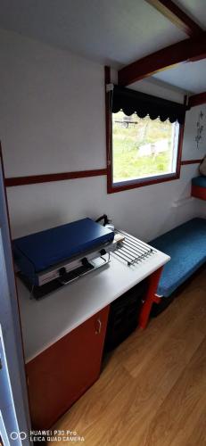 a small room with a desk and a window at Gypsy hut in Newtonmore