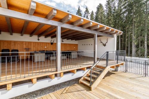a deck with a pergola on a house at Lipno - Lakeside Village - Větrník in Frymburk