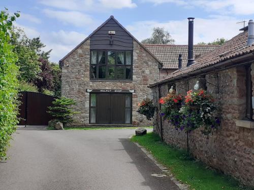 a brick house with a garage and a driveway at Orchard View Yurt & Hot Tub Somerset in Weston-super-Mare