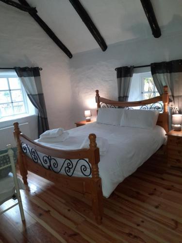 Posteľ alebo postele v izbe v ubytovaní Clarisses Cottage