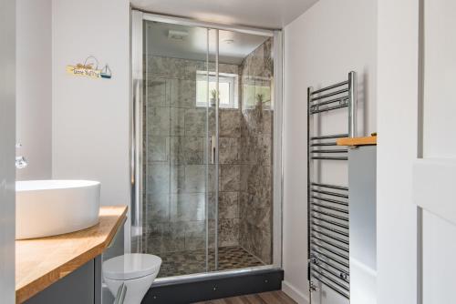 a bathroom with a shower and a sink at Castle View - Charming cottage with views of Dover Castle in Kent