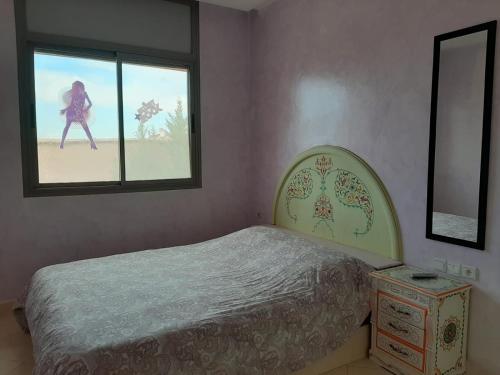 a bedroom with a bed and a window at Villa Marrackech Sbai in Oubadine