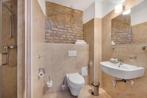 a bathroom with a toilet and a sink and a shower at Garni Hotel VIRGO in Bratislava