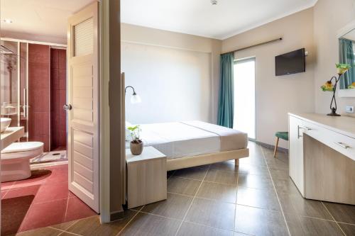 a bedroom with a bed and a bathroom at Elena Beach Hotel in Kissamos