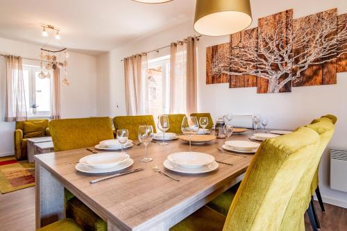 a dining room with a wooden table and chairs at Lipno - Lakeside Village - Větrník in Frymburk
