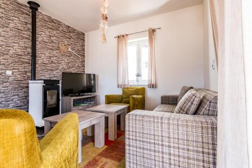 a living room with a couch and a tv at Lipno - Lakeside Village - Větrník in Frymburk
