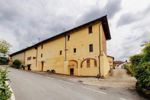 a large yellow building on the side of a road at La Valle B&B in Asti