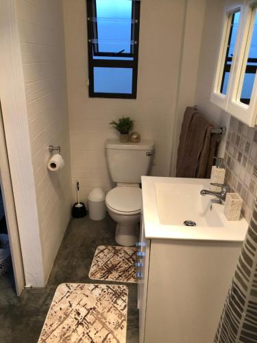 a bathroom with a toilet and a sink at Lala Pansie in Stilbaai